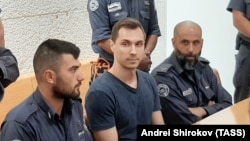 Russian citizen Aleksei Burkov (center) attends a court hearing in Jerusalem on November 3.