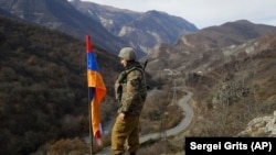 An ethnic Armenian soldier stands guard on a hill in the separatist region of Nagorno-Karabakh in November 2020.