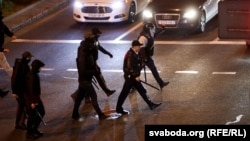 Riot police crack down on protesters in Minsk in September, led by Mikalay Karpyankou (in cap).