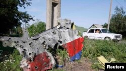 A piece of the wreckage is seen at a crash site of the Malaysia Airlines Flight 17 in the village of Petropavlivka in eastern Ukraine