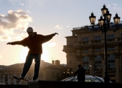 A skateboarder performs a trick -- sans mask -- in Manezh Square in central Moscow on March 19.