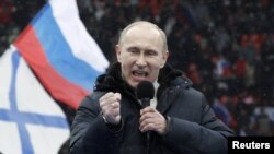 Vladimir Putin delivers a speech during the rally at Luzhniki Stadium on February 23.