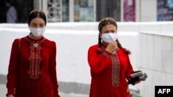 Turkmen women wearing face masks in Ashgabat in July. 