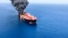 One of the two oil tankers is seen on fire in the sea off Oman on June 13.