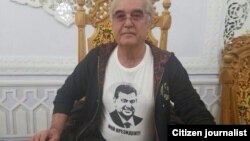 Salimbay Abdullaev, the new deputy chief of Uzbekistan's National Olympic Committee, wears a T-shirt bearing the face of Shavkat Mirziyaev that says "My President."