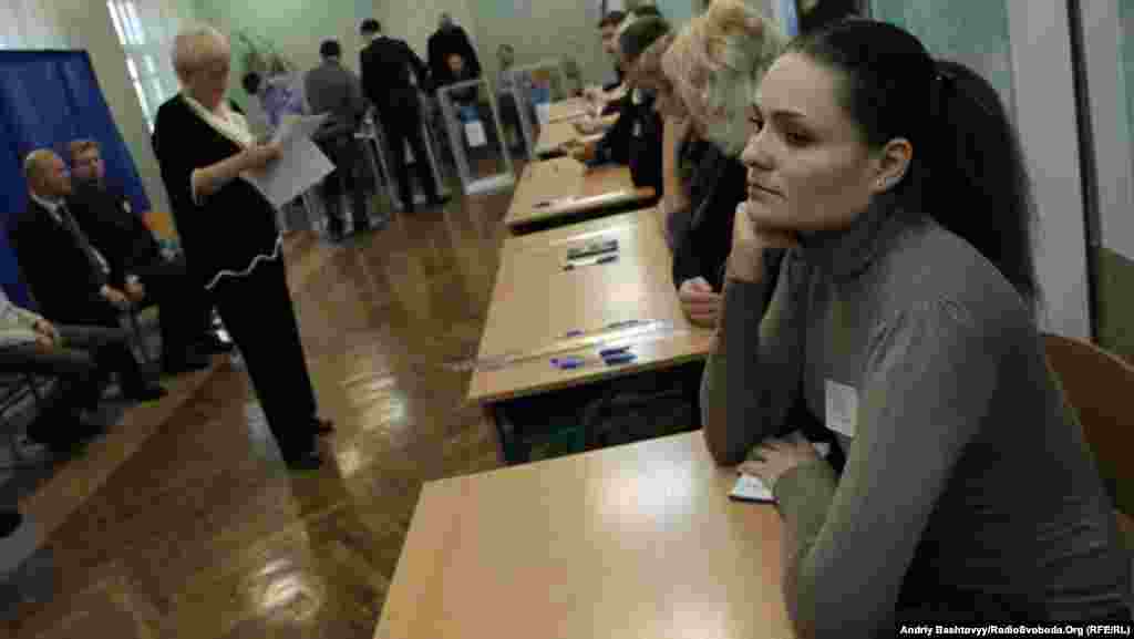 Election workers watch as voters take to the polls in the capital.