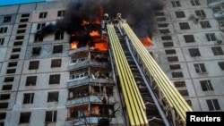 Firefighters work at the site of a Russian air strike in Kharkiv on September 15.