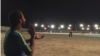 Afghanistan -- Players and spectators enjoy a nighttime cricket match in Lashkar Gah’s Wazir Akbar Khan stadium.