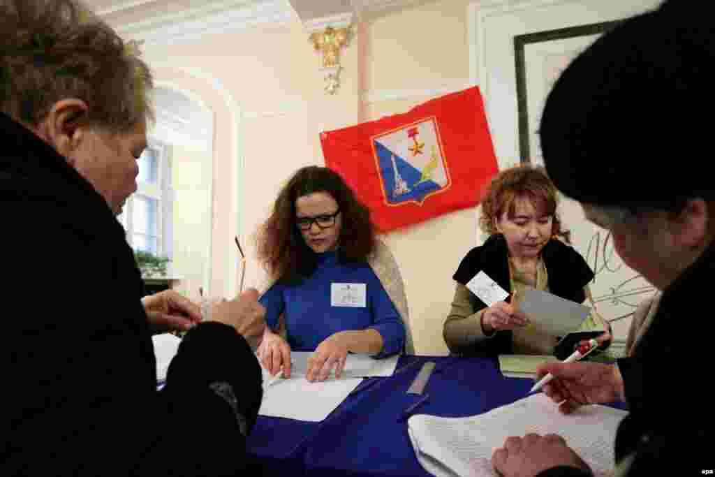 People sign in to vote at a polling station in Sevastopol.