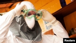 Dr. Kent Brantly wears protective gear at the case management center on the campus of ELWA Hospital in Monrovia, Liberia, in this undated handout photograph.