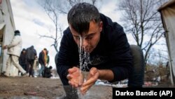 A migrant washes his face at the Vucjak refugee camp on December 6.