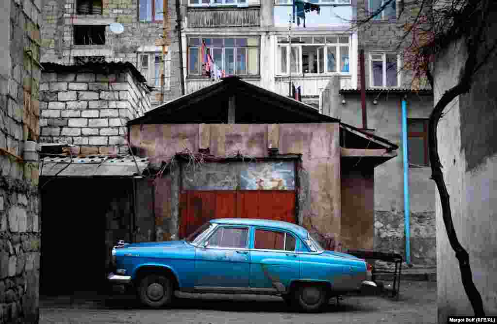 A Soviet-era Volga car in an alley in Stepanakert