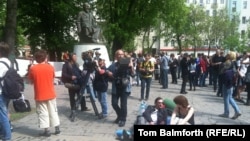 Russian protesters rest on camping mats in front of the statue of Abai in Moscow.