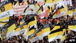 Russian ultranationalists wave tsarist black-yellow-white flags as they take part in the "Russian March" in central Moscow in November 2012.