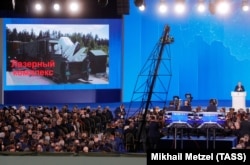 A video screen shows the Kinzhal shipborne surface-to-air missile system as Russian President Vladimir Putin delivers an annual address to the Federal Assembly in Moscow on March 1.