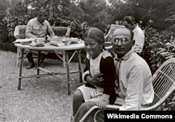 Lavrenty Beria (right) with Josef Stalin’s daughter, Svetlana, as the Soviet leader works in the background.