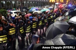 A police line in front of Tbilisi's old parliament building during speeches by protesters on the rainy evening of June 2.