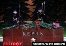 Flowers and candles at a memorial by the Kremlin walls in Moscow