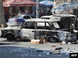 A burned-out car on a street in the captial, Yerevan, following deadly clashes between riot police and opposition protesters on March 1, 2008.