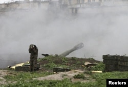 An ethnic Armenian serviceman launches artillery toward Azerbaijani forces from the town of Martakert in Nagorno-Karabakh on April 3.