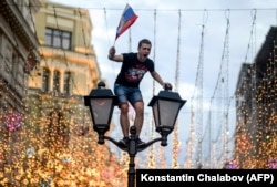 A Russian fan celebrates after the team's victory against Spain in central Moscow on July 1.