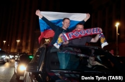 Russian football fans celebrate their team's win over Egypt in central Moscow.