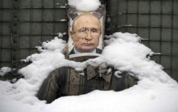 A bullet-riddled effigy of Russian President Vladimir Putin, coated in fresh snow, is seen at a frontline position in the Luhansk region of eastern Ukraine.