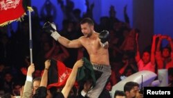 Afghan-German World Boxing Union champion Hamid Rahimi celebrates his victory over Said Mbelwa (not pictured) of Tanzania after their World Boxing Organization intercontinental middleweight fight in Kabul on October 30.