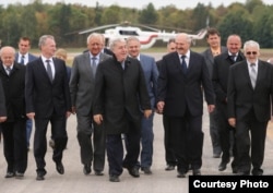 Mikhail Gutseriyev (center) walks with Alyaksandr Lukashenka. (undated)