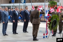 Retired General Ante Gotovina (left), Croatian President Zoran Milanovic (center), and Croatian Prime Minister Andrej Plenkovic attend a ceremony marking the 25th anniversary of a military victory that ended the country's war for independence on August 5, 2020, in Knin.