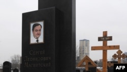 The grave of lawyer Sergei Magnitsky with his portrait on the tomb at the Preobrazhenskoye cemetery in Moscow.