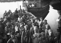 Captured Red Army soldiers look on after the battle.