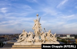 Above the entrance to Keleti train station, the gods of water (left) and fire flank a woman wielding steam, the combination of the two elements.