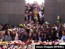 Armenians commemorate the anniversary of the mass killings by laying flowers around the eternal flame inside the Yerevan memorial.