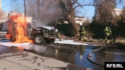 Firefighters at the scene of a car bombing that killed Oleksandr Kharaberyush in March of this year.