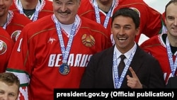 Dzmitry Baskau (right) appears with President Alyaksandr Lukashenka at a Christmas ice-hockey tournament in early January 2017.