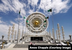 A young couple walks out of the Alem Cultural and Entertainment Center, a building topped by the world's largest indoor ferris wheel.