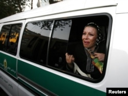 A woman cries inside a police van after being arrested by the morality police in Tehran. (file photo)