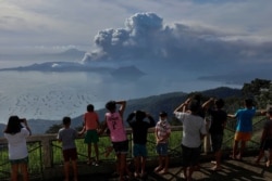 Filipinos watch the Taal eruption from the relative safety of Tagaytay City, about six kilometers from Taal's caldera, on January 13