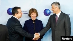 Ashton looks on as Serbian Prime Minister Ivica Dacic (left) shakes hands with his Kosovar counterpart Hashim Thaci during talks in Brussels earlier this month.