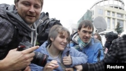 Freed Pussy Riot member Yekaterina Samutsevich (center) leaves the courtroom in Moscow on October 10.