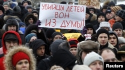 Protesters rally against the law banning Americans from adopting Russian children in St. Petersburg on January 13. The sign reads, "Murderers of children, get out of the Duma."