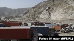 A convoy of trucks waits in the Khyber Pass area of the Pakistani-Afghan border on July 4 for word that the crossings are open again.