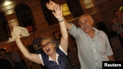 Supporters of the opposition Georgian Dream coalition celebrate exit poll results in Tbilisi.