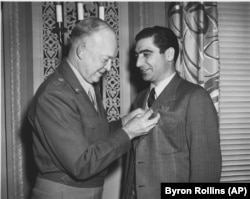 U.S. General Dwight D. Eisenhower (left) presents the Medal of Freedom to Robert Capa in November 1947 in Washington, D.C.