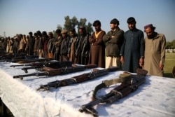 Former militants surrender their weapons during a reconciliation ceremony in Jalalabad in December 2019.