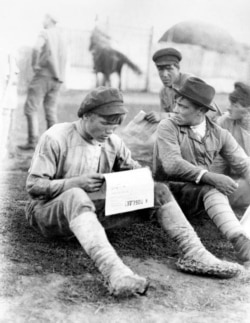 Red Army soldiers reading a newspaper while assigned to the Polish Front.