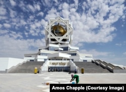 A woman wrings a rag dry while cleaning the tiles around Ashgabat’s wedding palace.