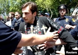 Georgian police try to stop an Orthodox Christian activist during clashes at a rally to mark International Day Against Homophobia in Tbilisi on May 17.