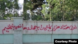 Graffiti reads: "We will never forgive the warlords for the blood they shed of 70,000 people in Kabul," sprayed on a wall at Kabul University